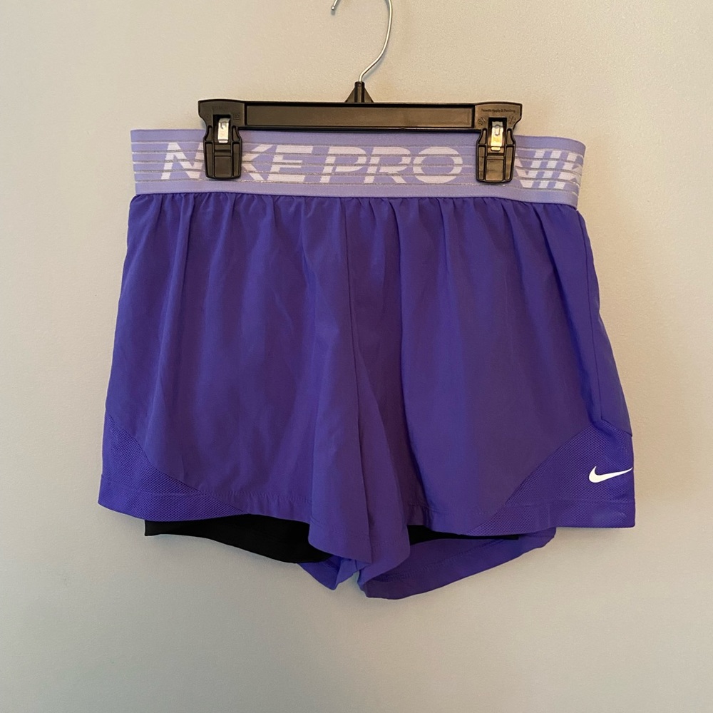 Purple Nike pro shorts with black compression shorts